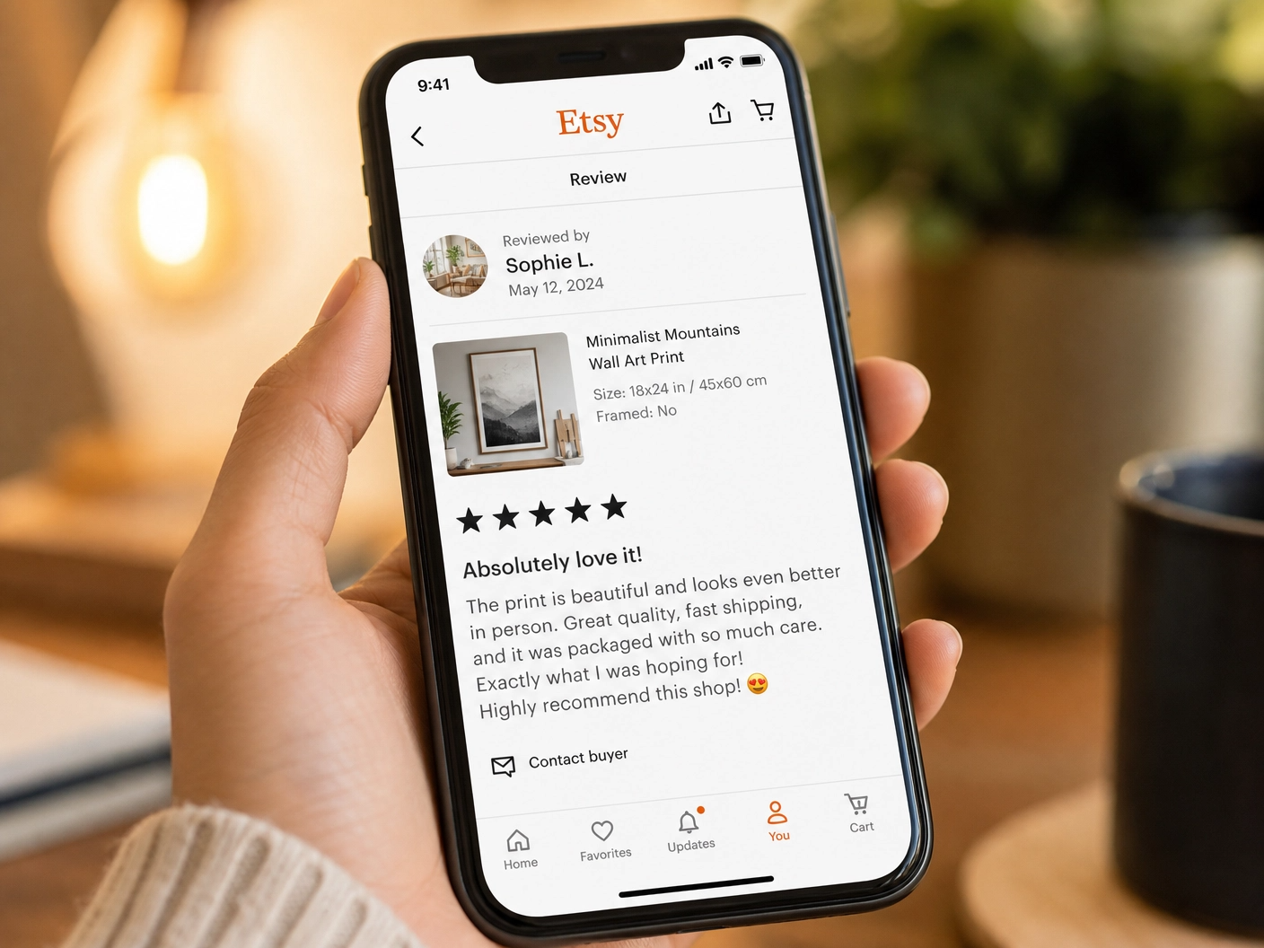 Smartphone displaying a 5-star Etsy review for a print-on-demand product, held by an Asian hand.