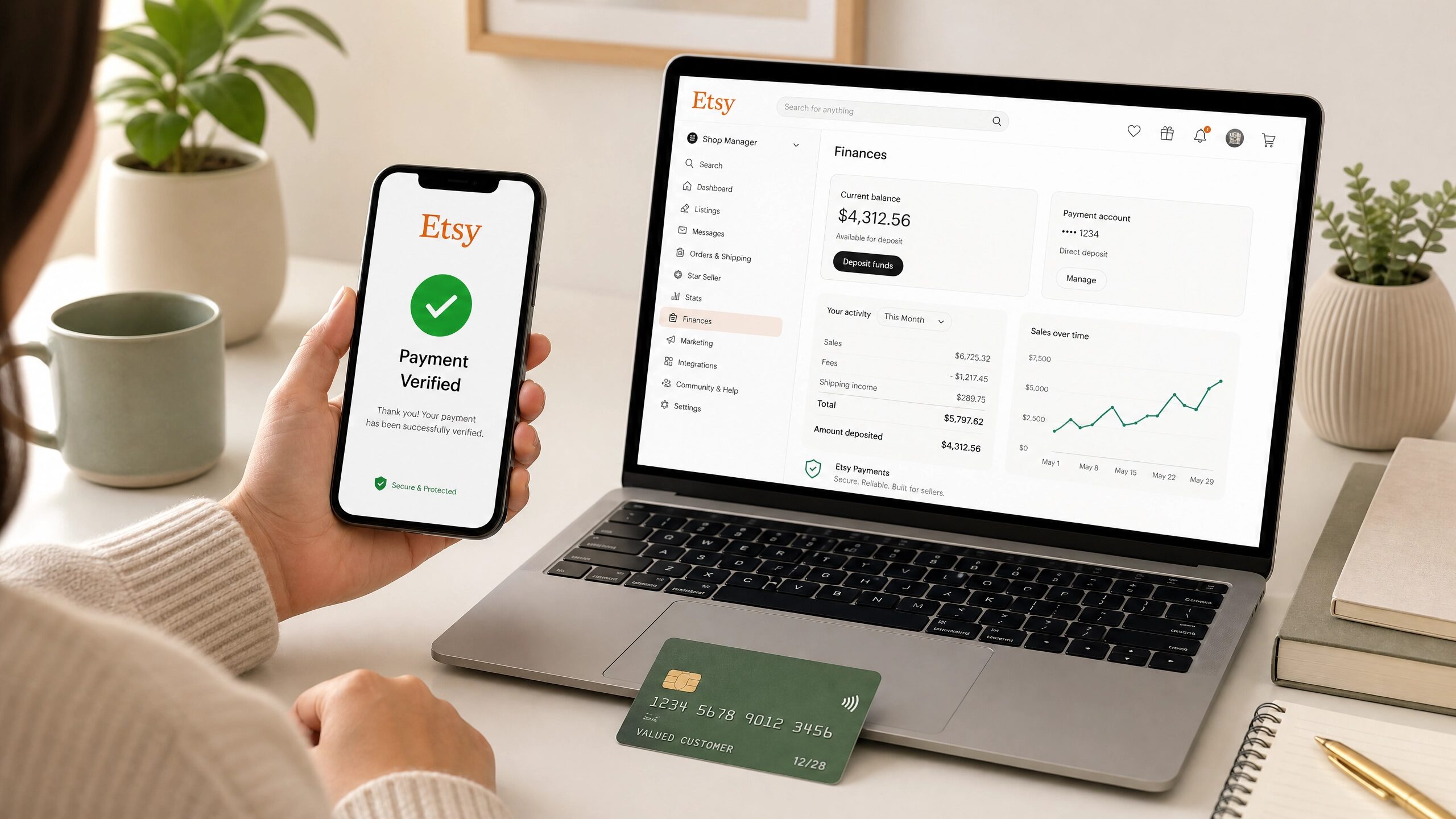 A faceless person verifying an Etsy payment on a smartphone, with a laptop showing financial data.