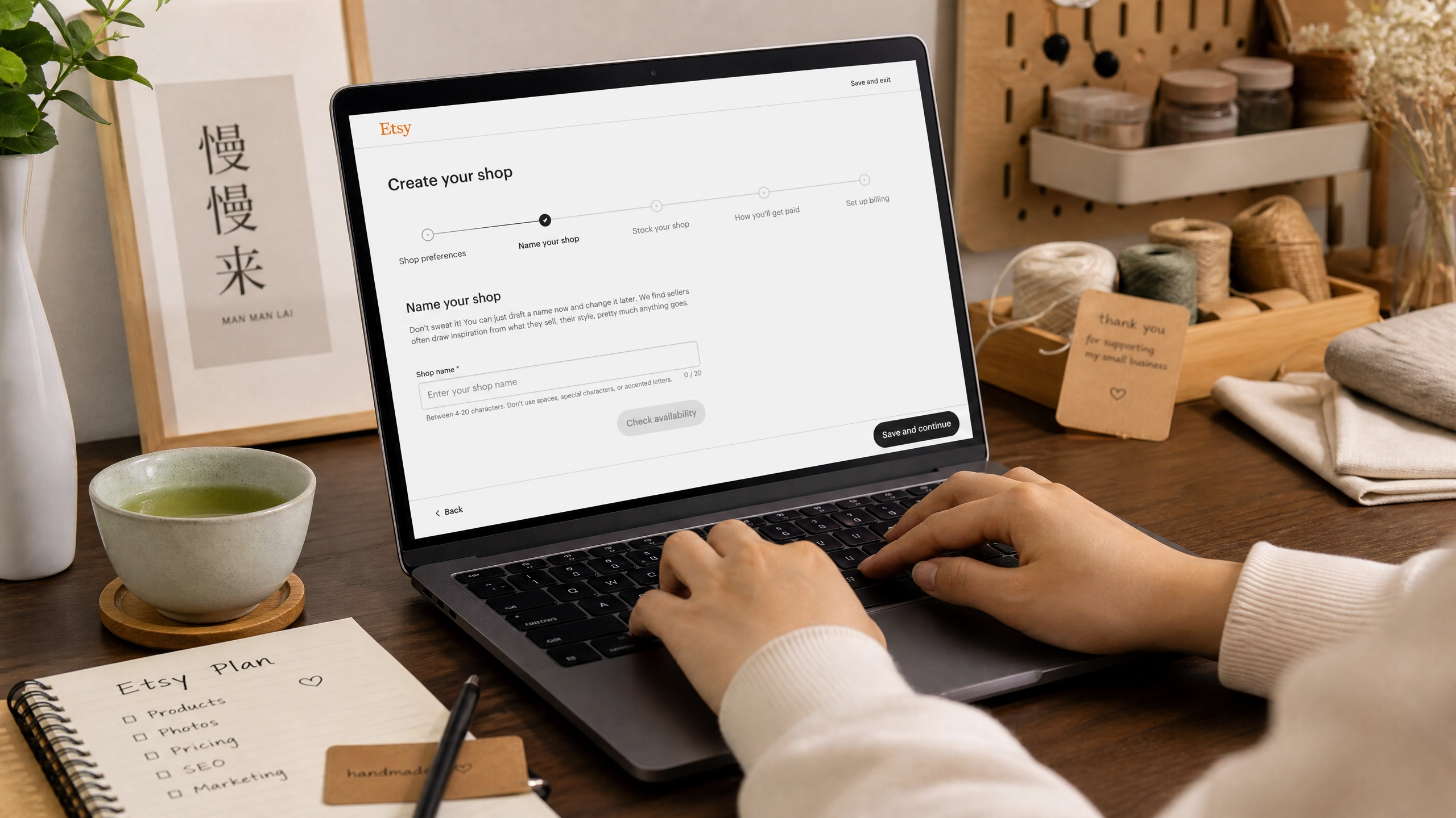 Asian entrepreneur setting up an Etsy store on a MacBook, showing the Etsy shop creation interface.