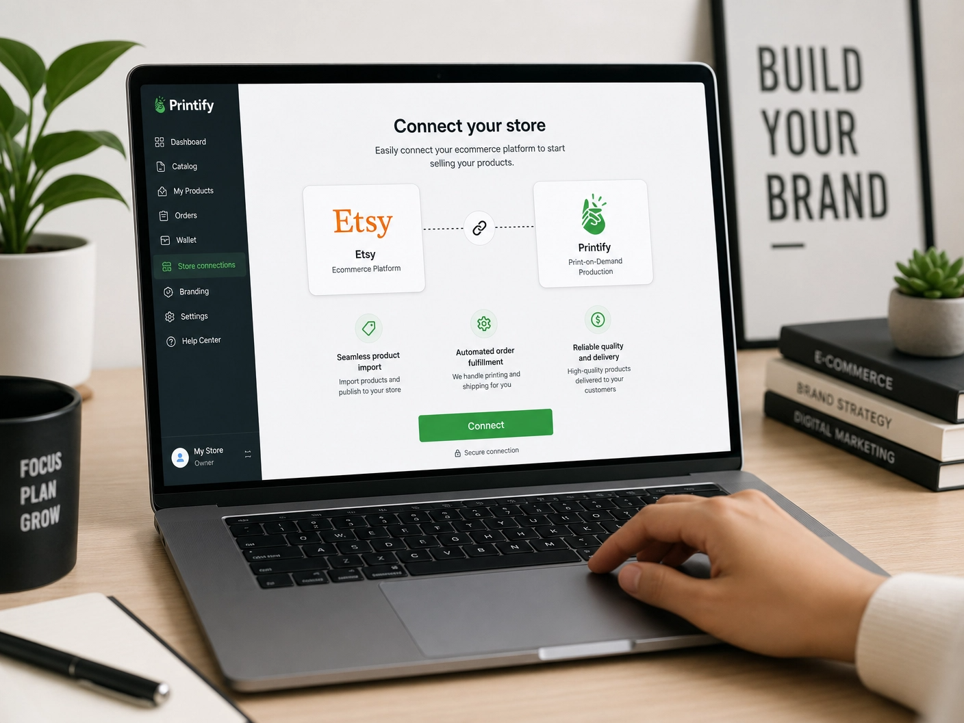 Laptop screen showing Etsy connecting to a print-on-demand platform, with an Asian hand clicking the connect button.